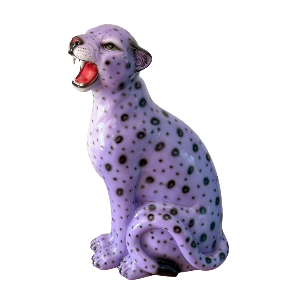 Purple leopard figurine with open mouth on a white background
