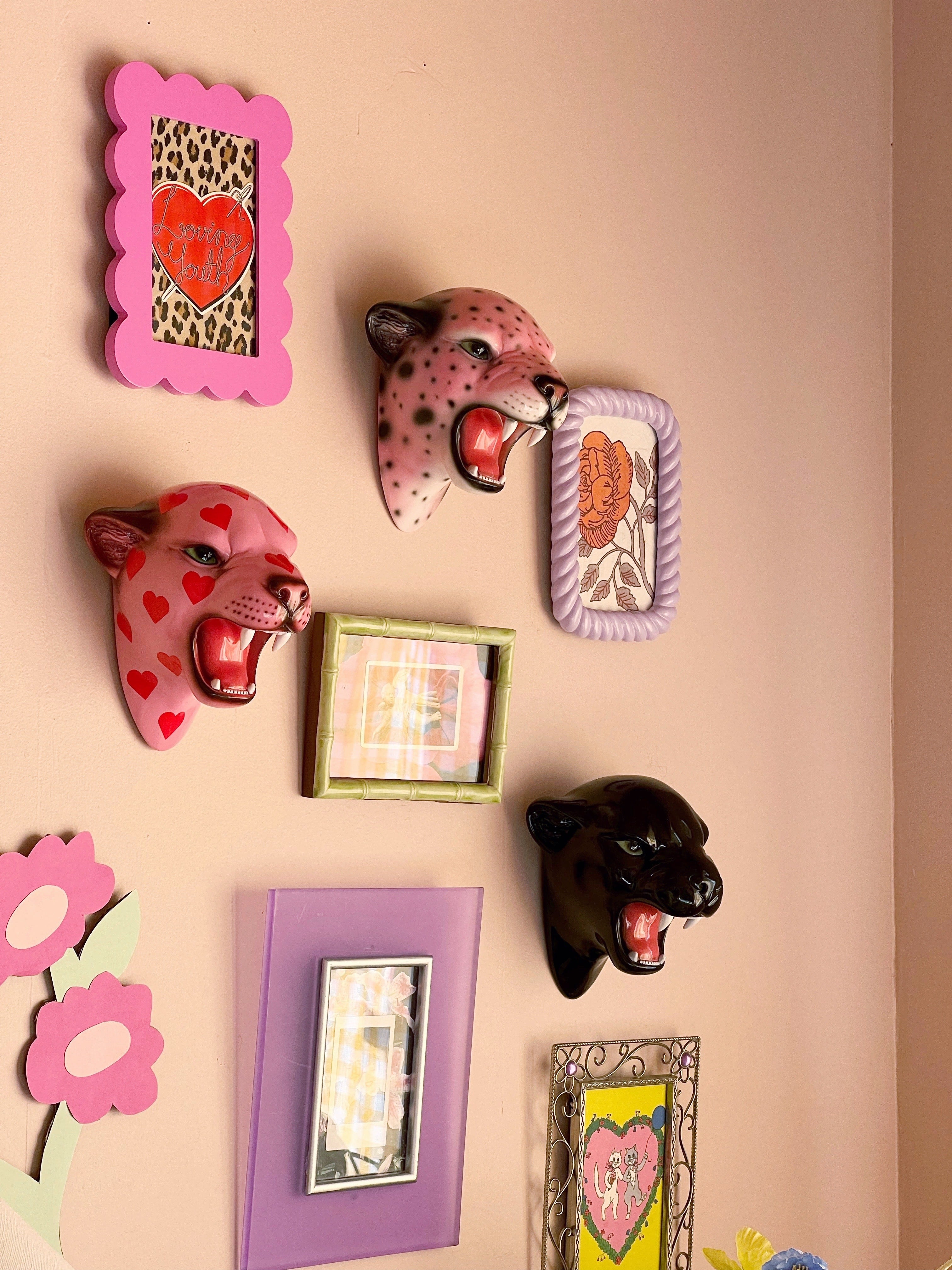 gallery wall with wall mounted leopard heads