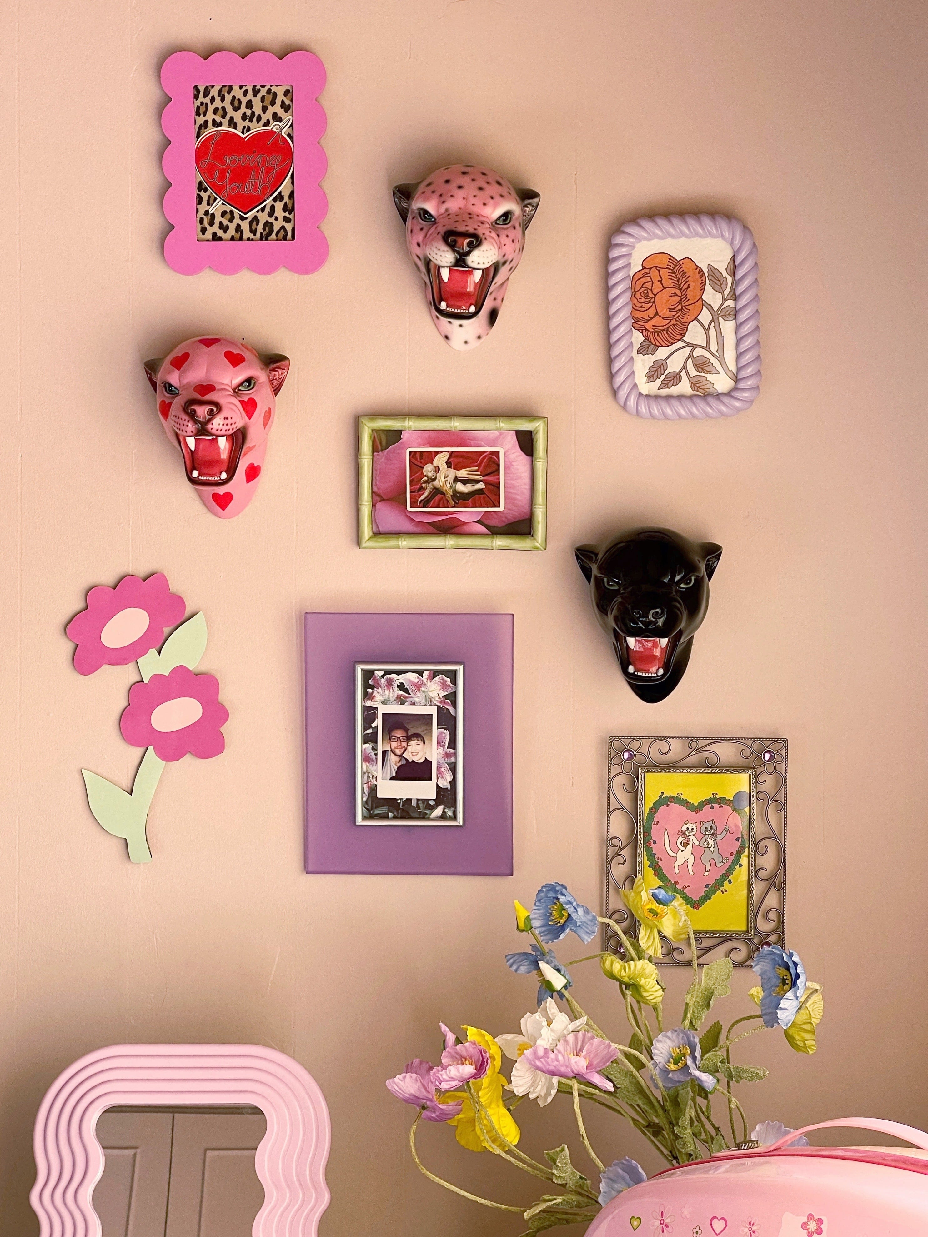gallery wall with wall mounted leopard heads
