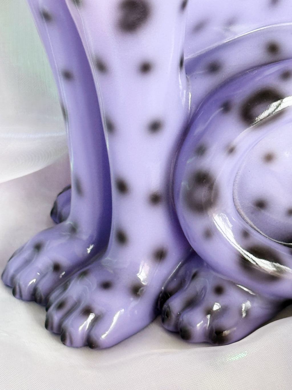 Close up of feet on a purple leopard resin figurine