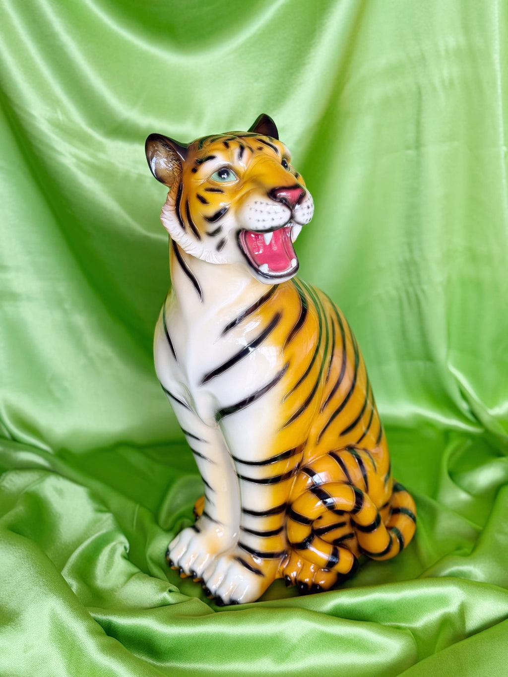  resin tiger figurine on a green fabric background
