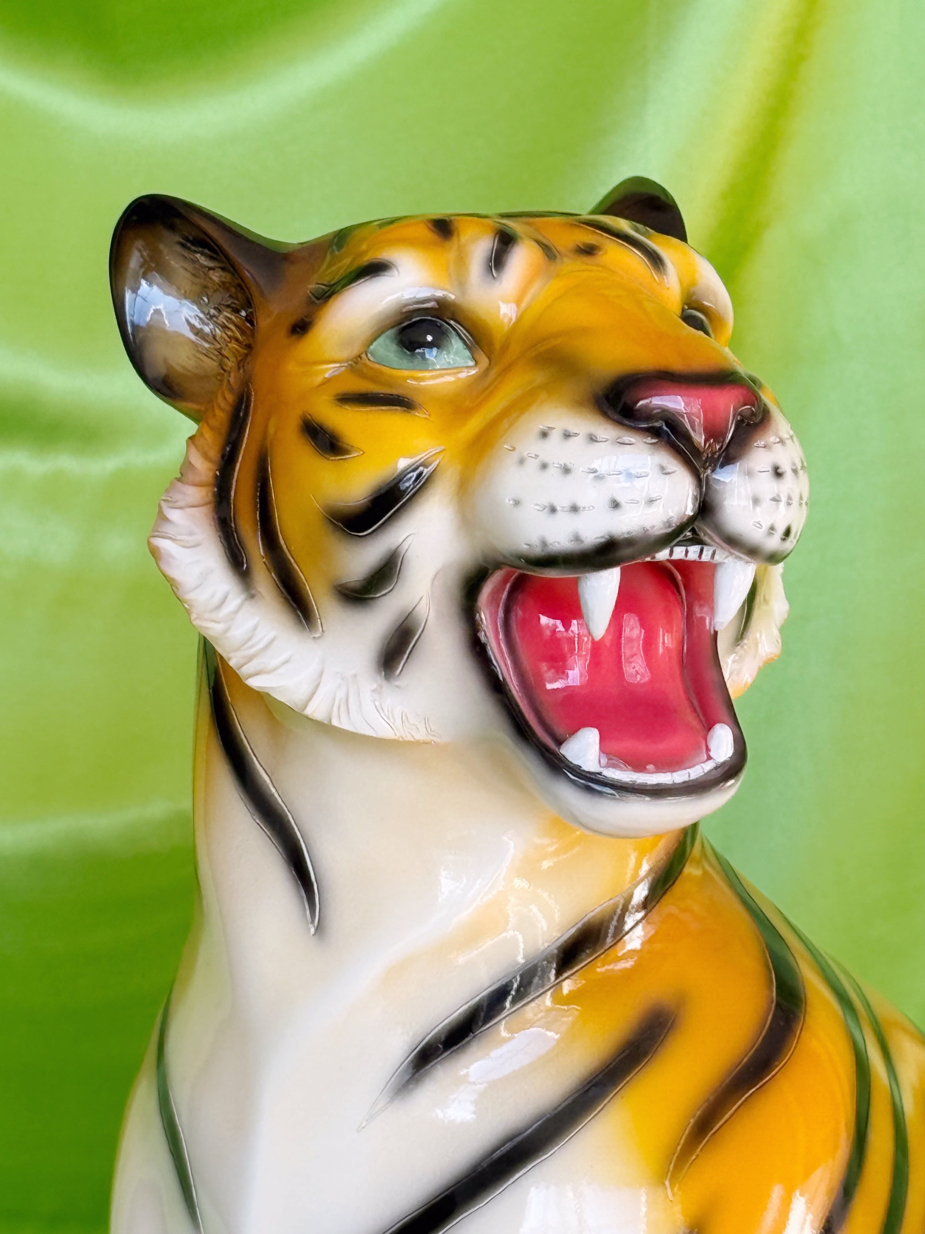  resin tiger figurine with open mouth on a green background