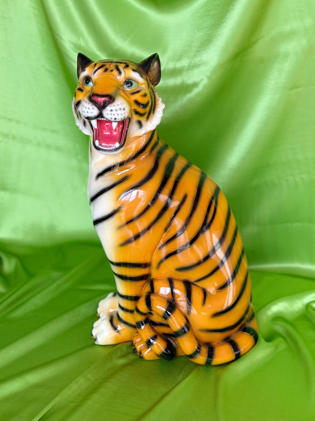  resin tiger figurine on a green fabric background