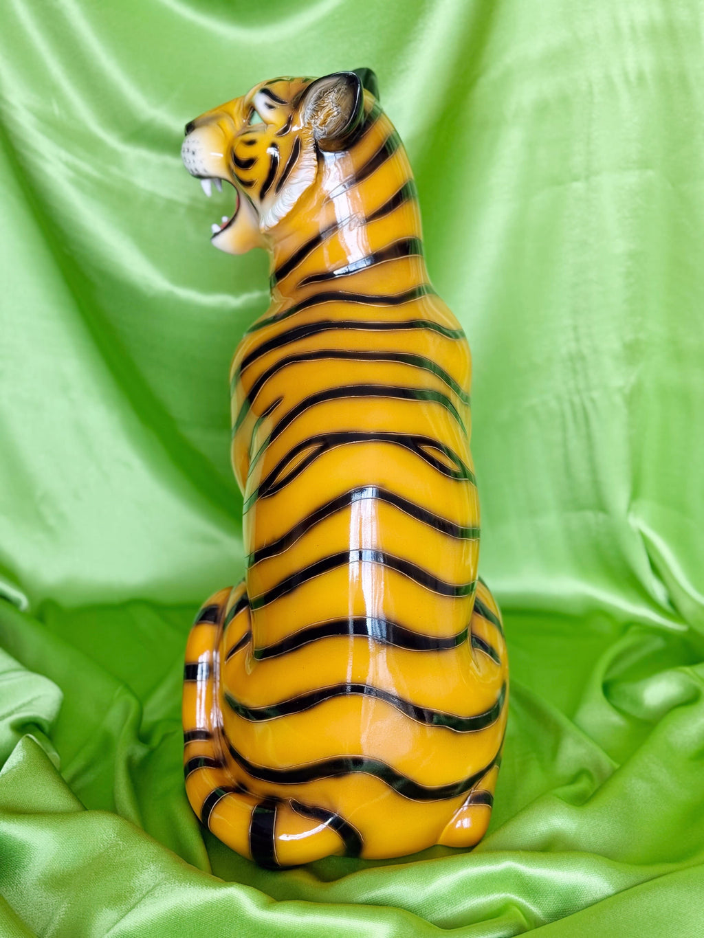  resin tiger figurine on a green fabric background