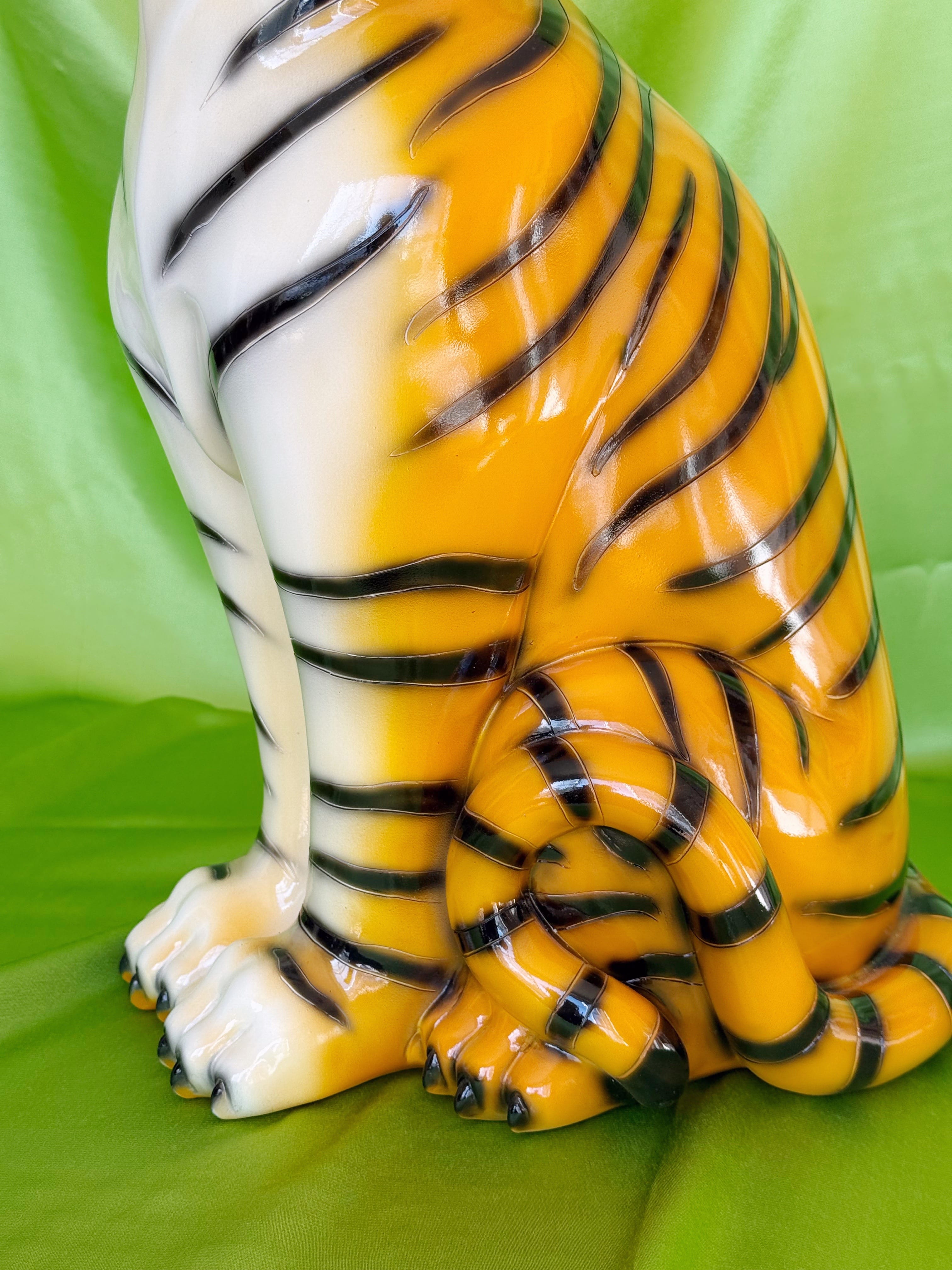  resin tiger figurine on a green fabric background