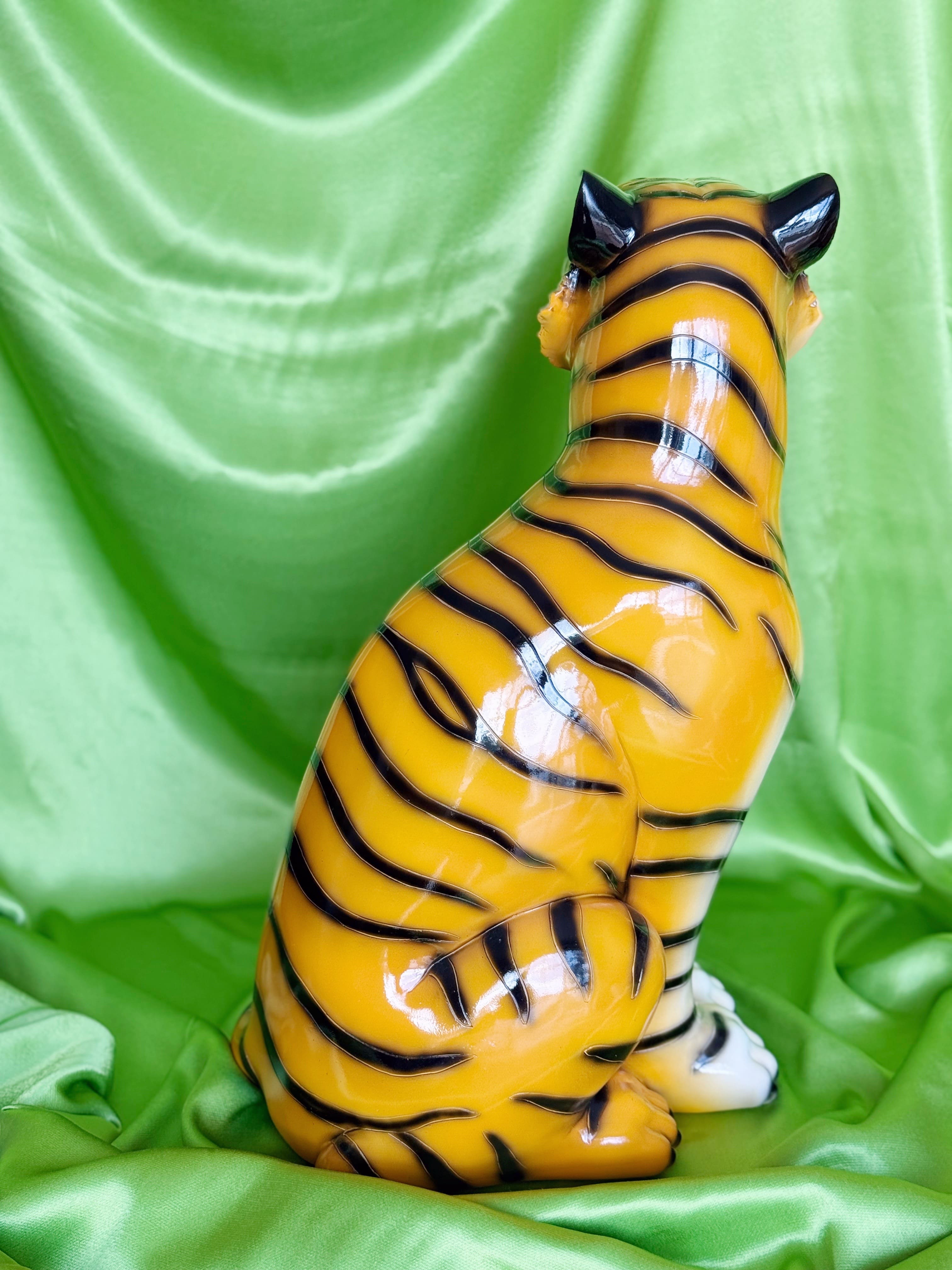  resin tiger figurine on a green fabric background