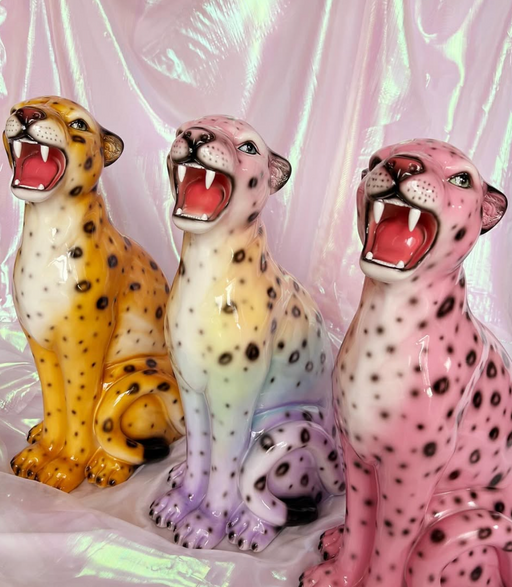 three different coloured leopard statues