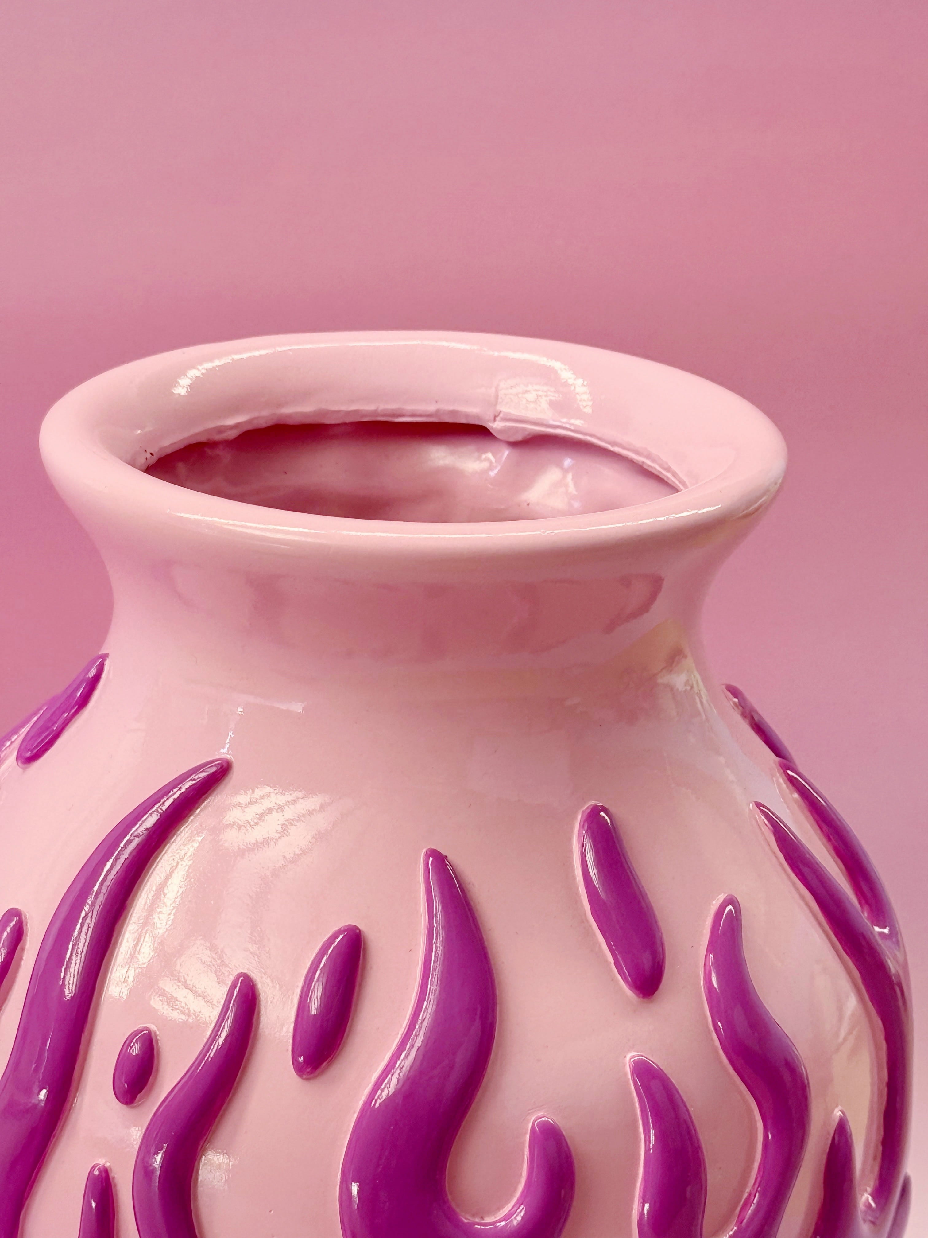 Pink vase with purple flame patterns on a pink background