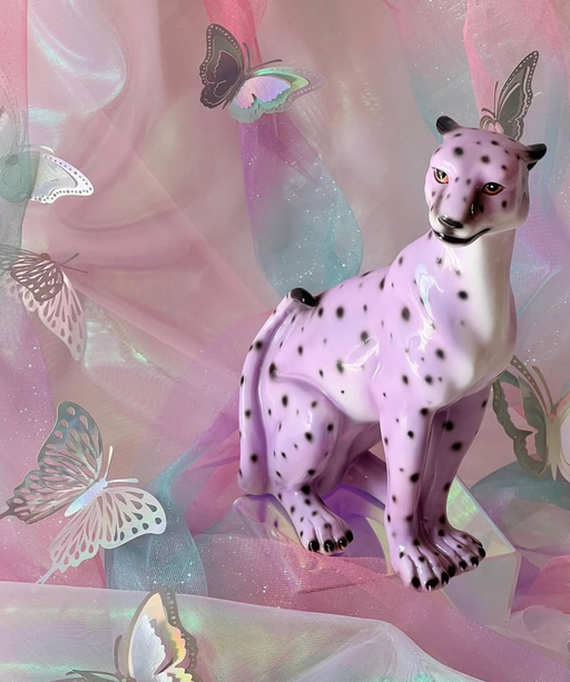 lilac leopard statue with sparkly background and silver butterflies