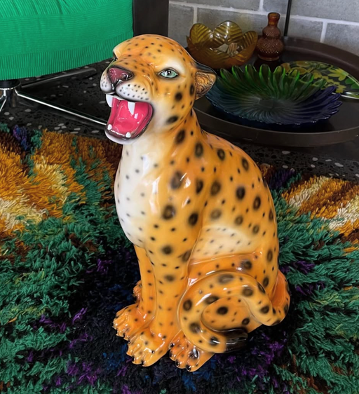 natural leopard statue on green vintage rug