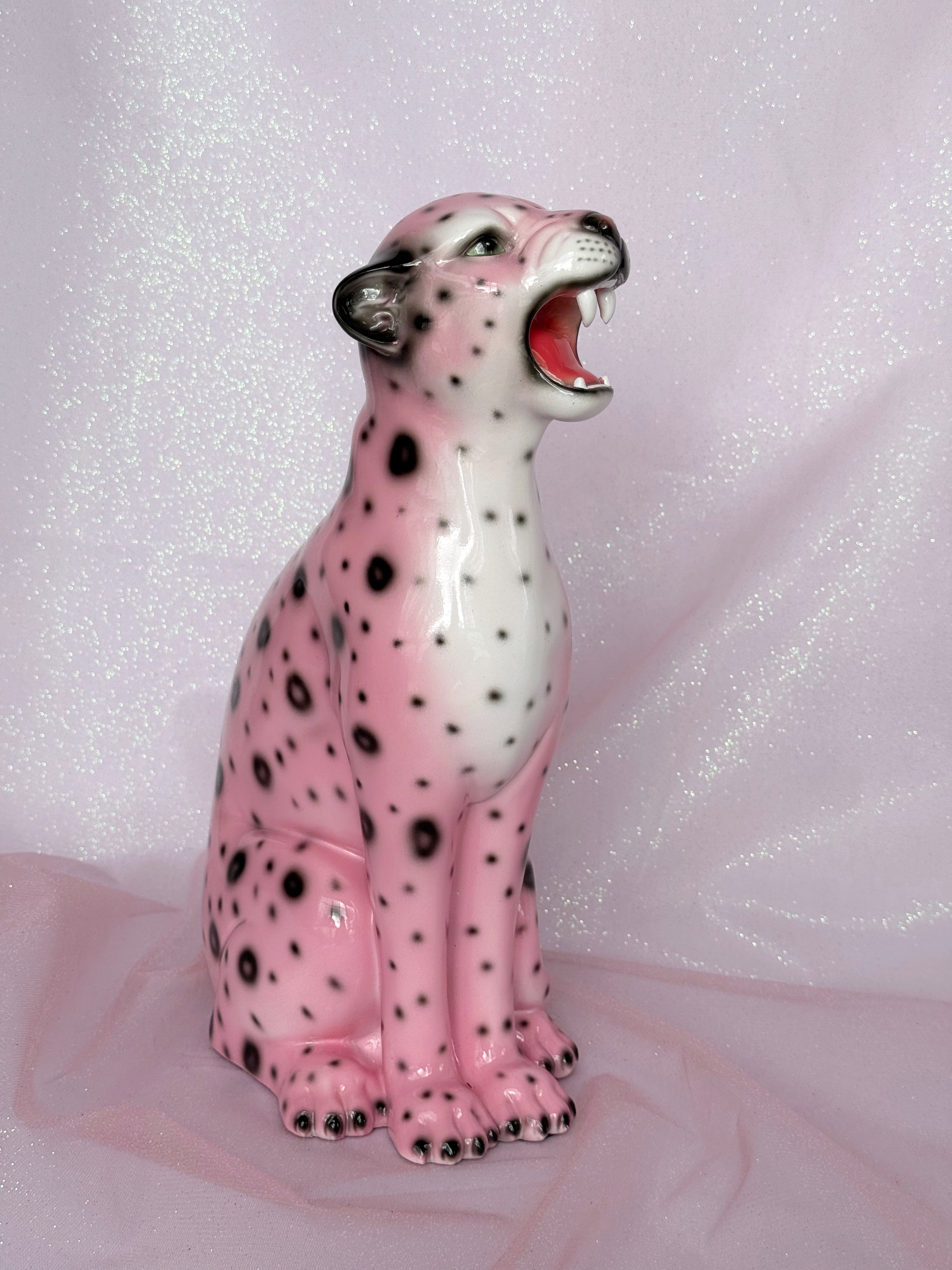 Pink ceramic leopard figurine on a glittery pink background