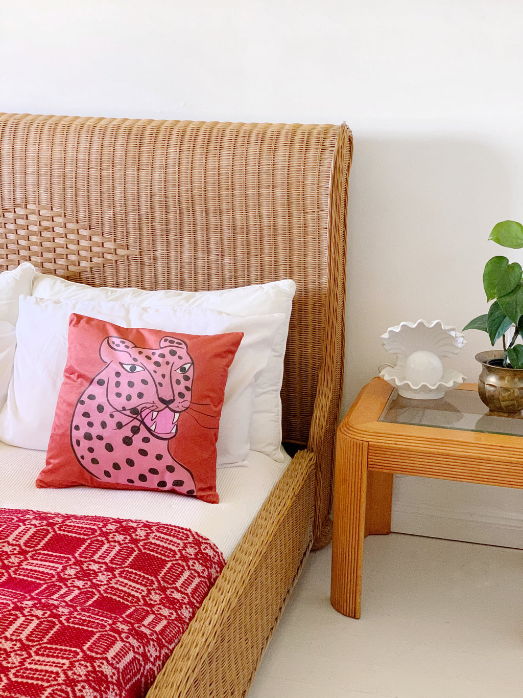 rust leopard cushion on bed