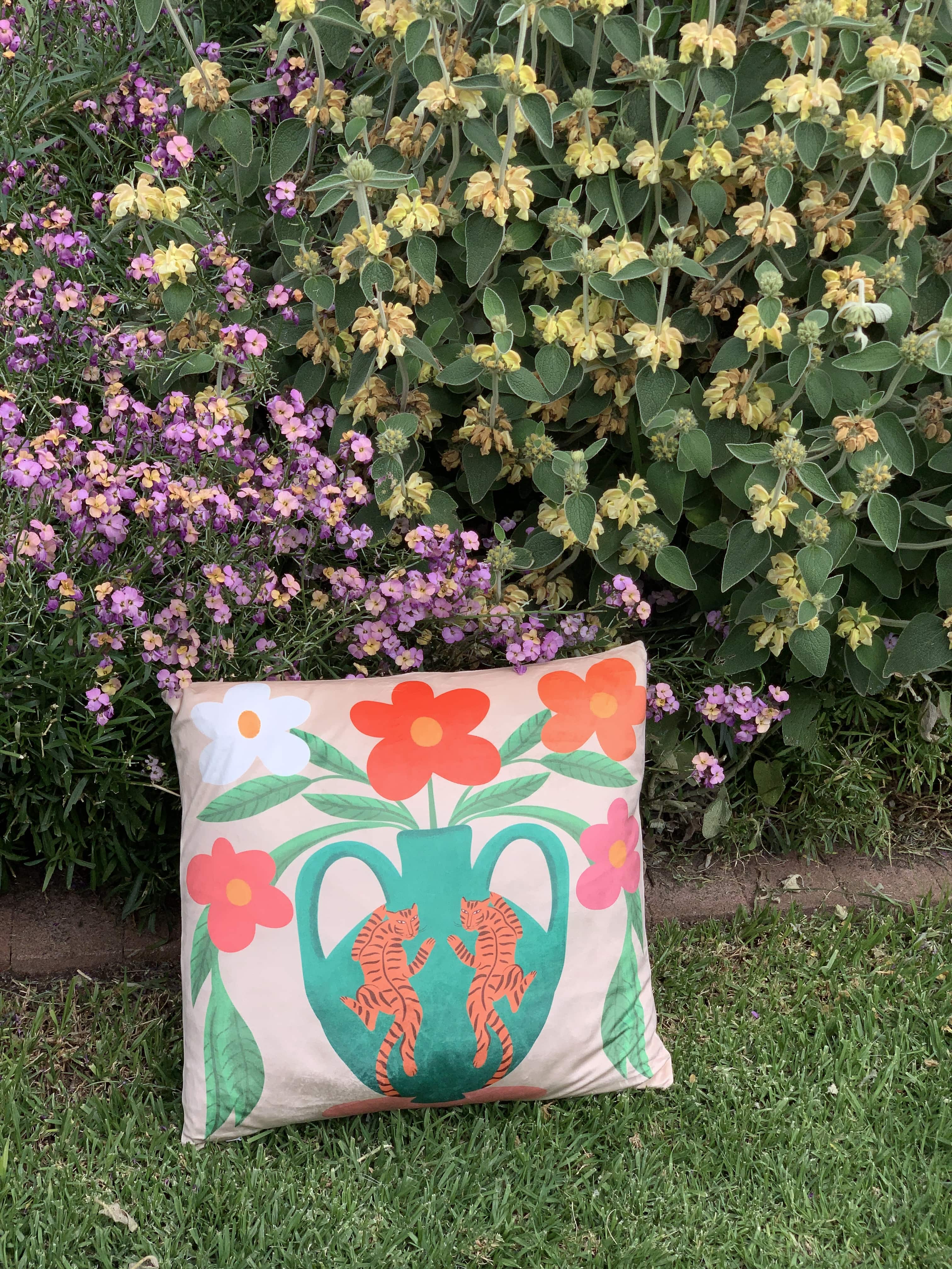 colourful tiger vase cushion cover with flower bushes in background